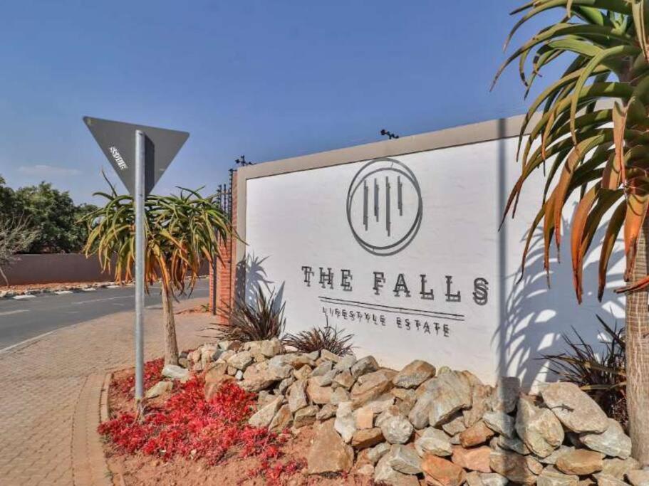 a sign for the falls theatre centre on a street at Lovely Apartment in Roodepoort in Roodepoort