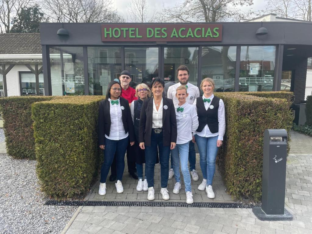 a group of people standing in front of a building at Logis Hôtel Restaurant Des Acacias Lille Tourcoing in Neuville-en-Ferrain