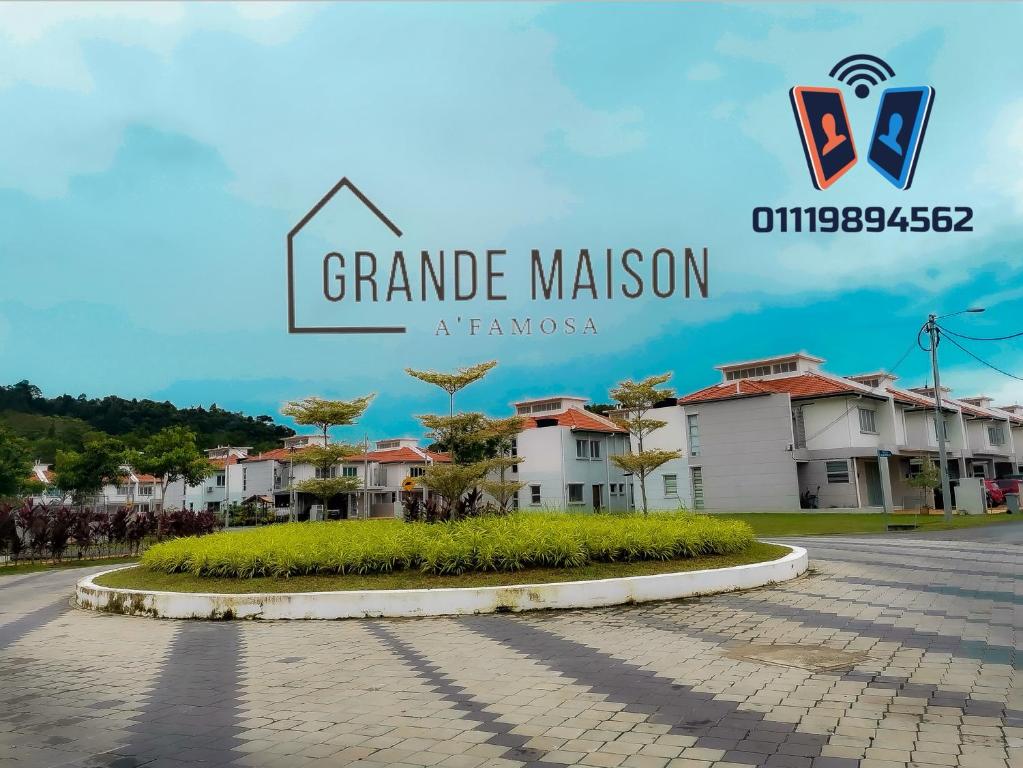 a sign for grandame mansion in front of some houses at Grande Maison Homestay A'Famosa Golf view Near WATERPARK l UITM l HONDA l Netflix free l wifi 100mbps in Kampong Alor Gajah