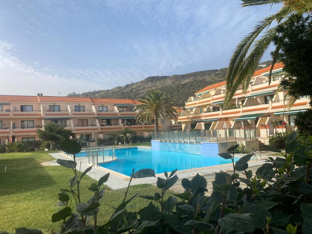 ein Hotel mit einem Swimmingpool vor einem Gebäude in der Unterkunft Cascada de colores in Los Cancajos