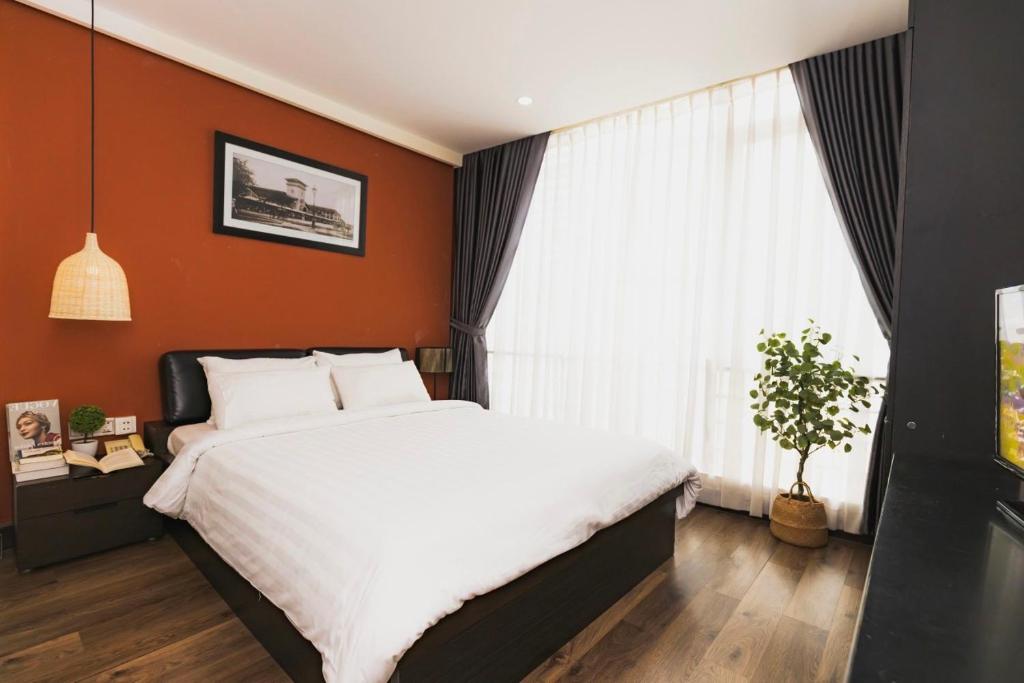 The One Premium Hotel tesisinde bir odada yatak veya yataklar