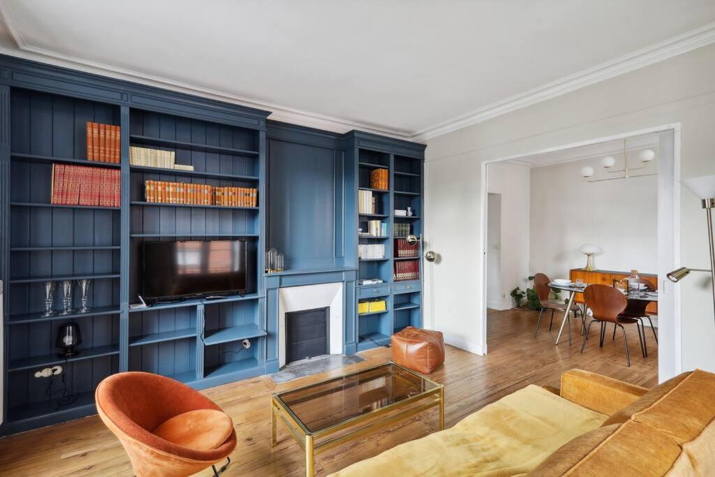 un salon avec des armoires bleues et une cheminée dans l'établissement Michel Columb elegant - en centre ville, à Nantes