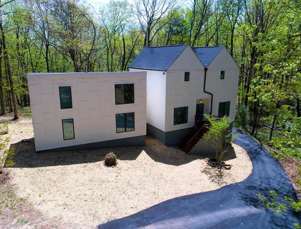 a large white house in the middle of the woods at The Getaway House ATL in Carrollton