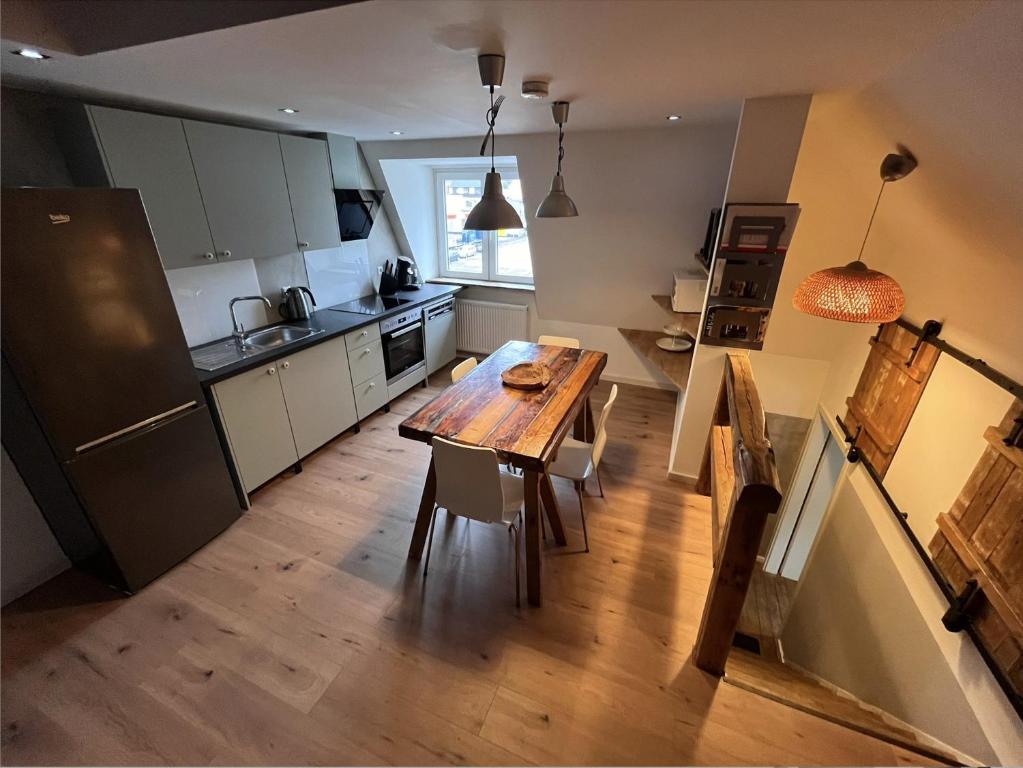 a kitchen with a wooden table and a wooden floor at Bielefeld Zentral in Bielefeld