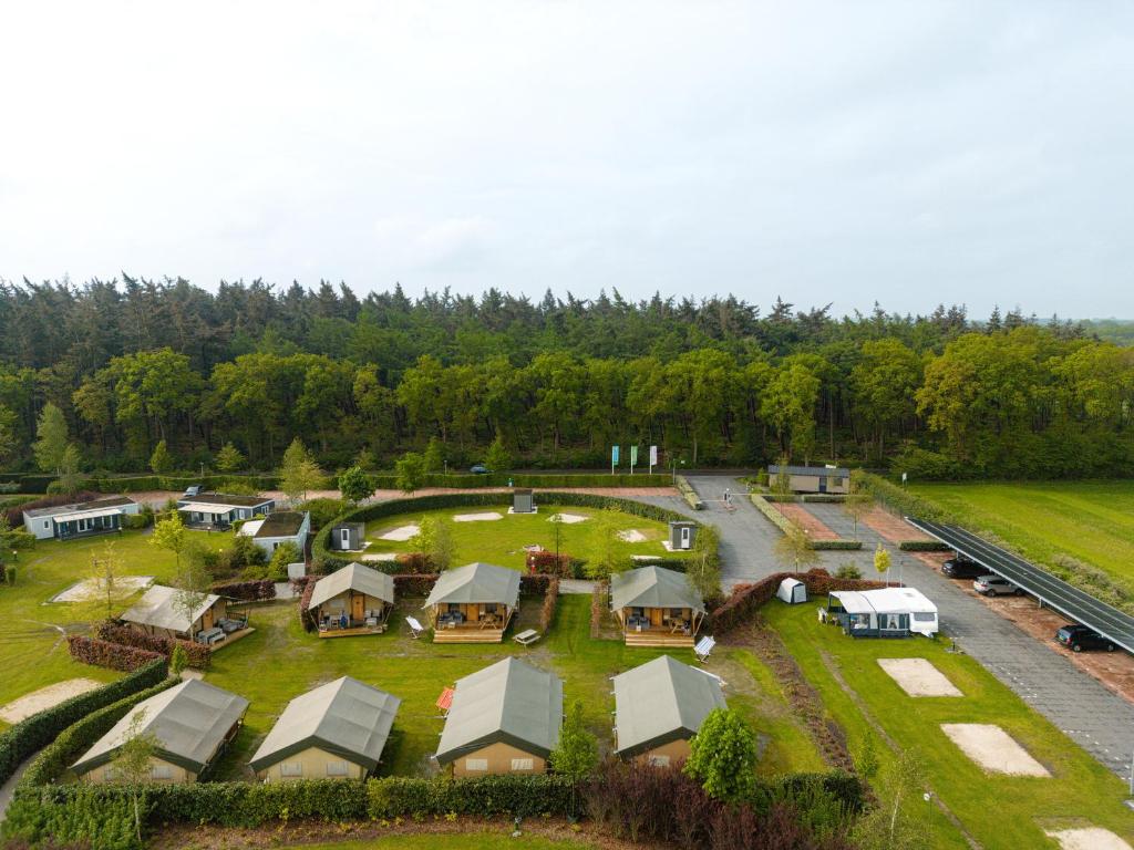 an aerial view of a farm with a group of tents at Glamping Ackersate in Voorthuizen