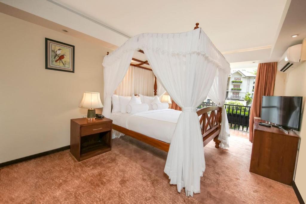 Postel nebo postele na pokoji v ubytování Serene Kandy