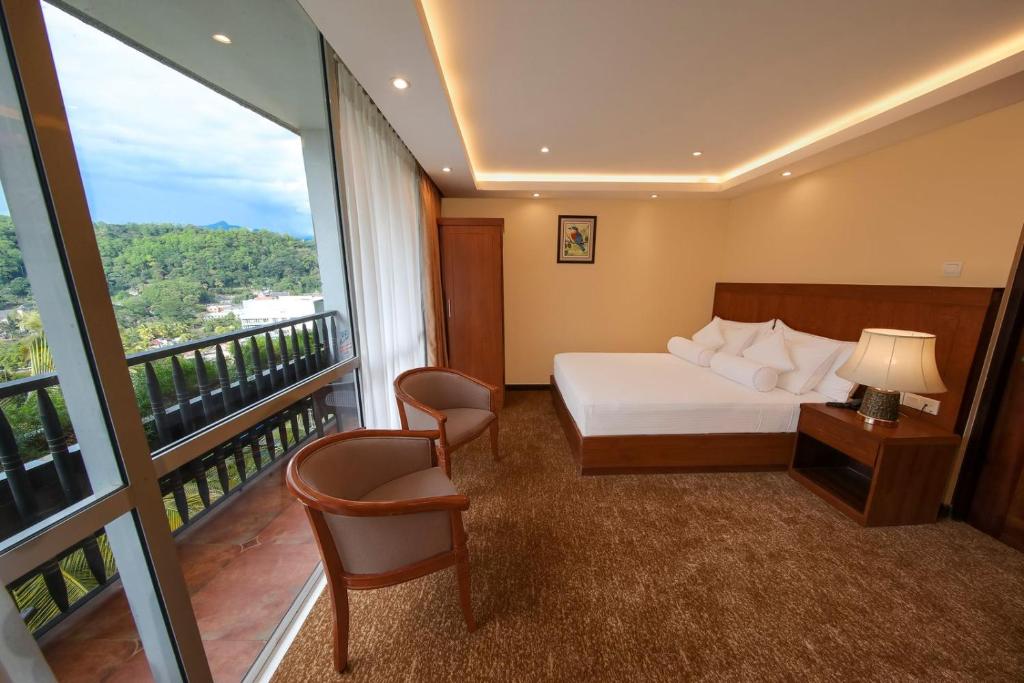 Postel nebo postele na pokoji v ubytování Serene Kandy