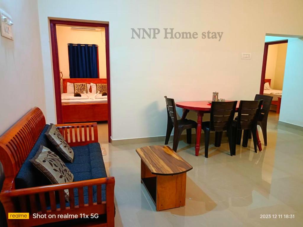 a living room with a couch and a table and chairs at NNP Home Stay Rameswaram in Rāmeswaram