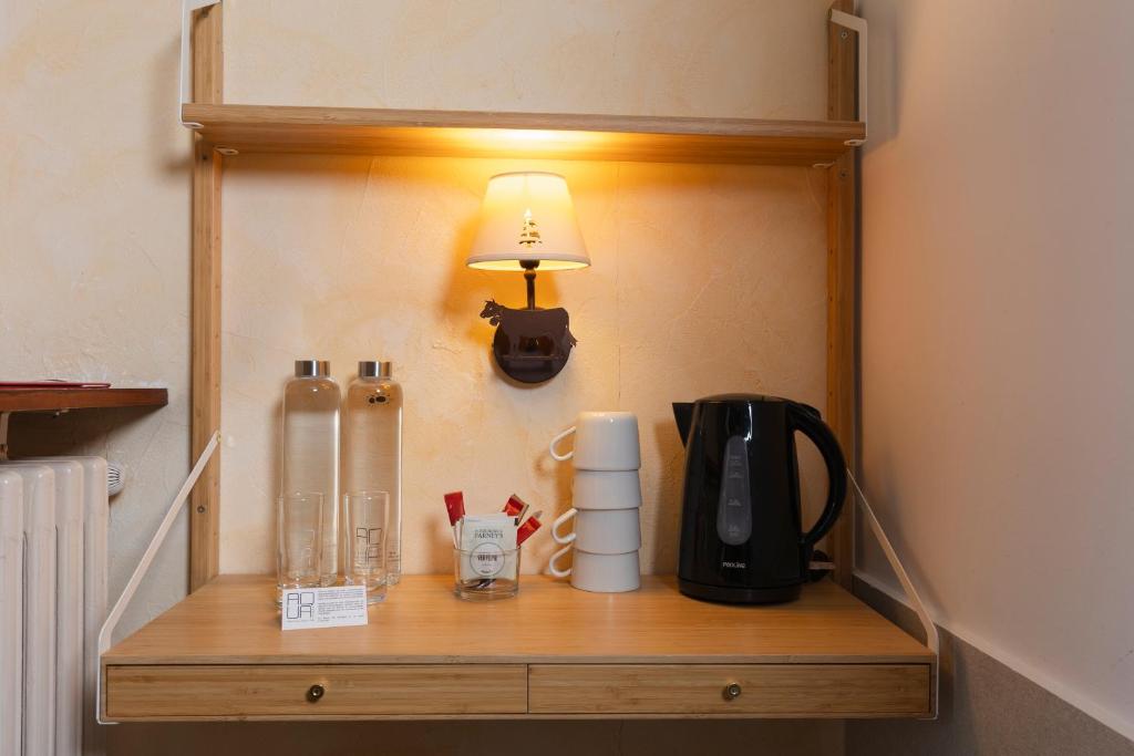 a wooden shelf with a lamp and a coffee maker on it at Le Saint Antoine in Les Houches