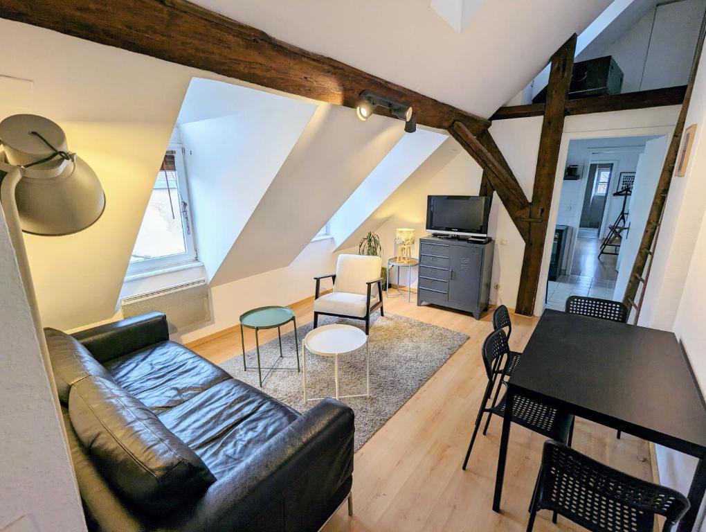 a living room with a couch and a table at Appartement des Serruriers in Strasbourg
