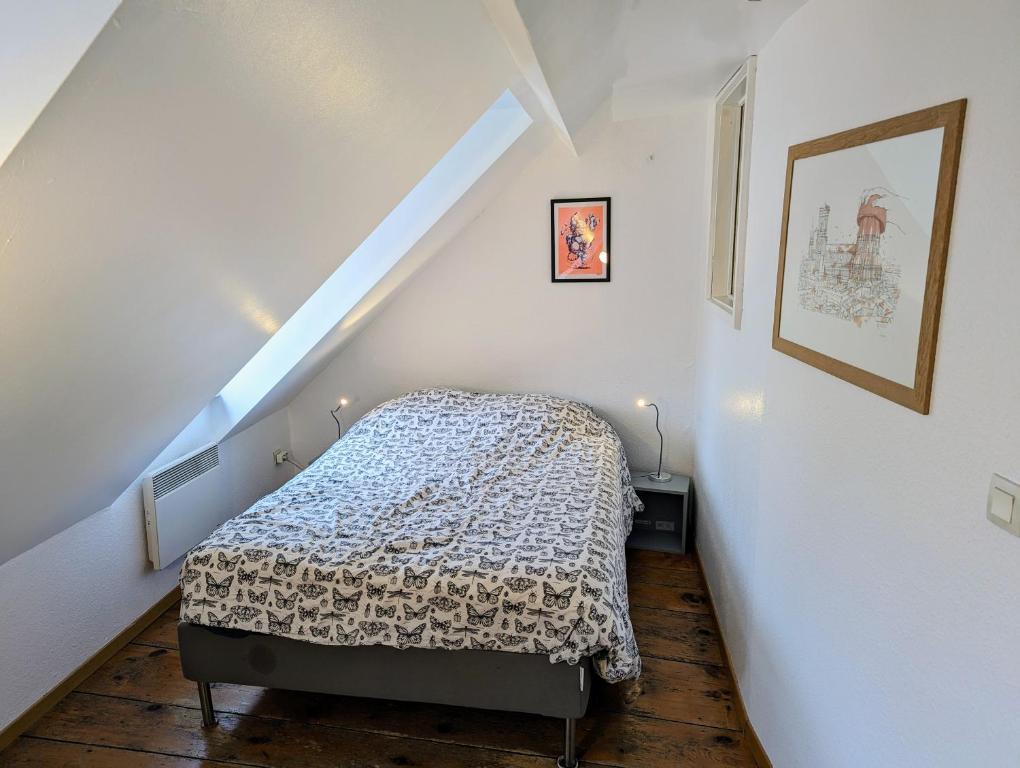 a small bedroom with a bed in a attic at Appartement des Serruriers in Strasbourg