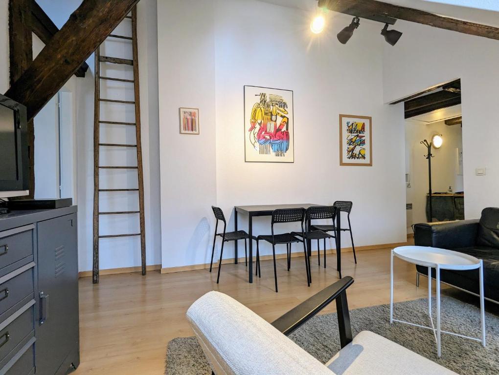 a living room with a table and chairs at Appartement des Serruriers in Strasbourg