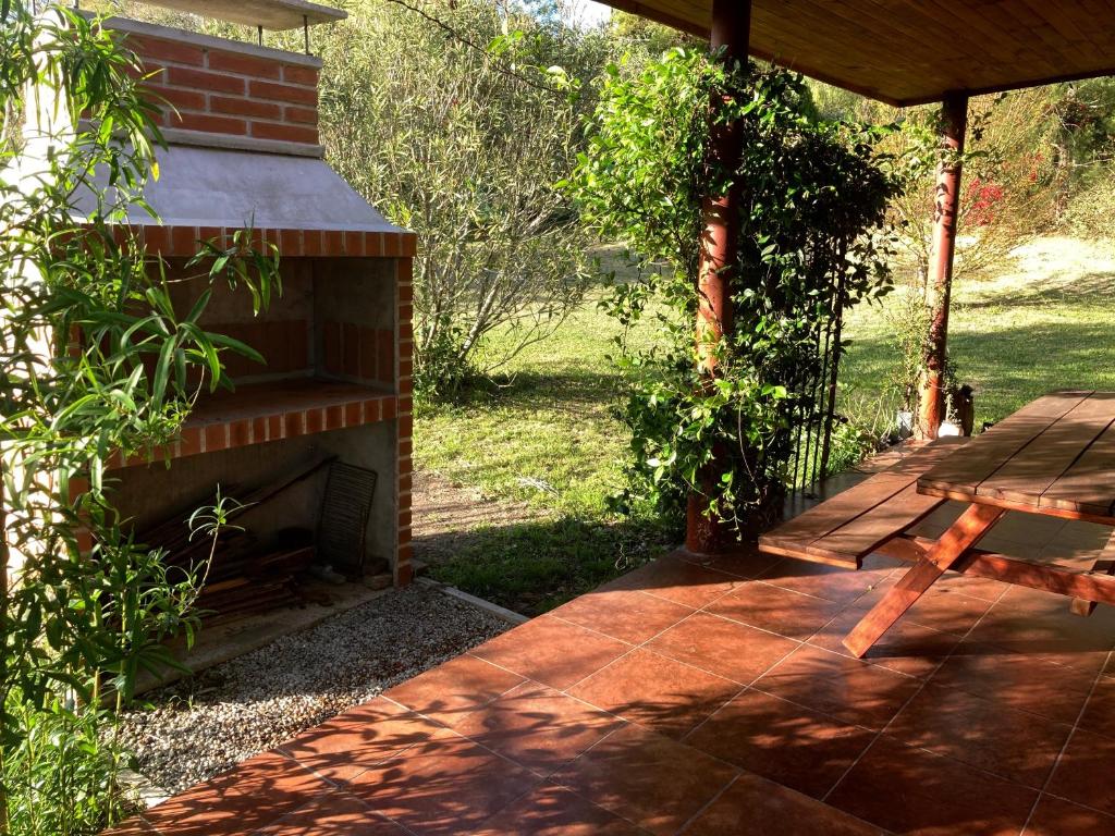 a porch with a wooden bench and a fireplace at AbbeyHouse descanso y vacaciones in Victoria