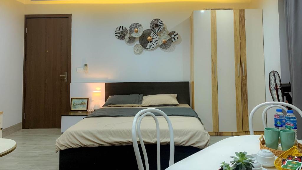 a bedroom with a bed and a clock on the wall at Green Line Long Bien - Serviced Apartment - Ngoc Thuy - Hanoi in Hanoi