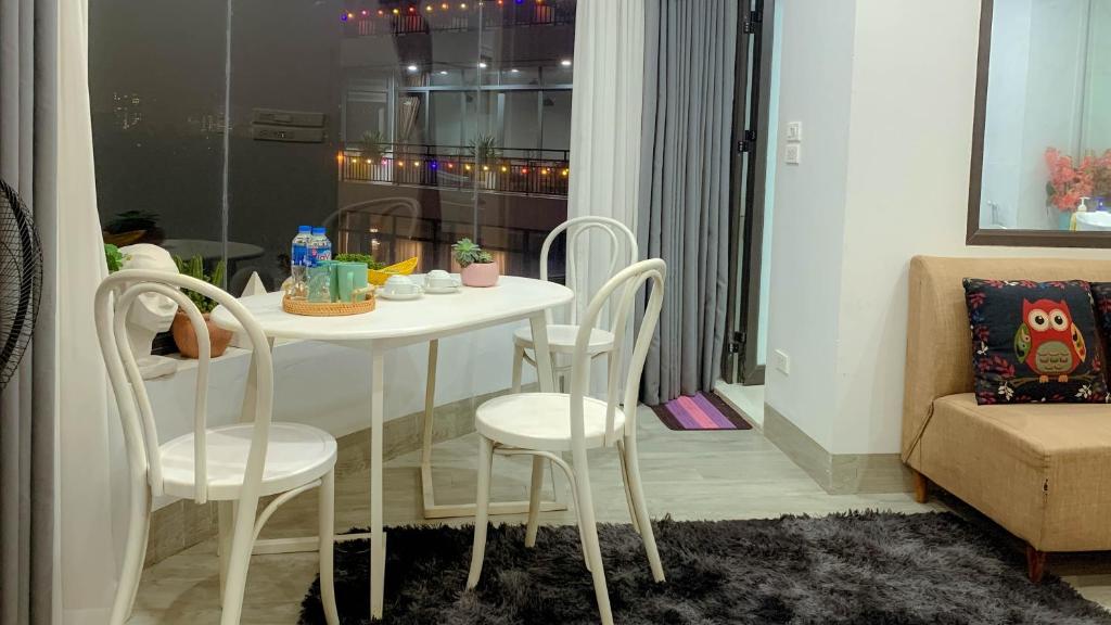 a white table and chairs in a living room at Green Line Long Bien - Serviced Apartment - Ngoc Thuy - Hanoi in Hanoi