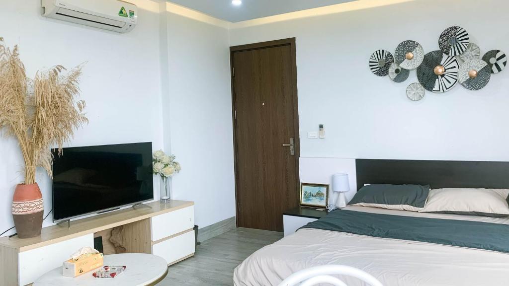 a bedroom with a bed and a flat screen tv at Green Line Long Bien - Serviced Apartment - Ngoc Thuy - Hanoi in Hanoi
