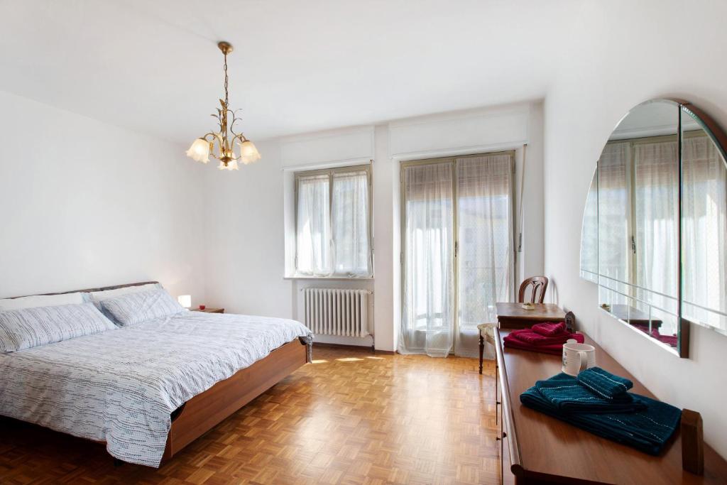 a bedroom with a bed and two windows at Maison Blanchet in Sarre