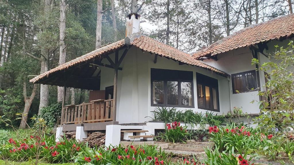 a small house with a cross on top of it at Kartika Lodge in Bengkok
