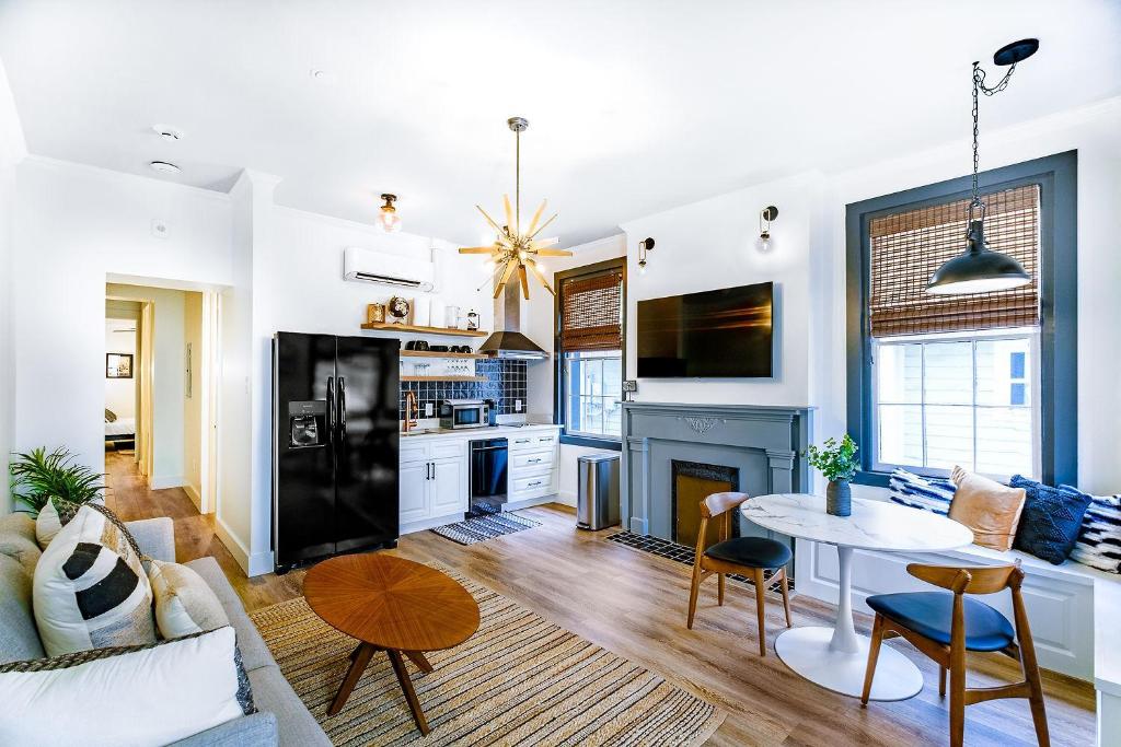 a living room with a table and a kitchen at Old Spanish House- B, The Carter Jack Suite in Biloxi