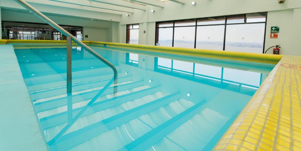 a swimming pool with stairs in a building at Camino Real Aeropuerto in Mexico City