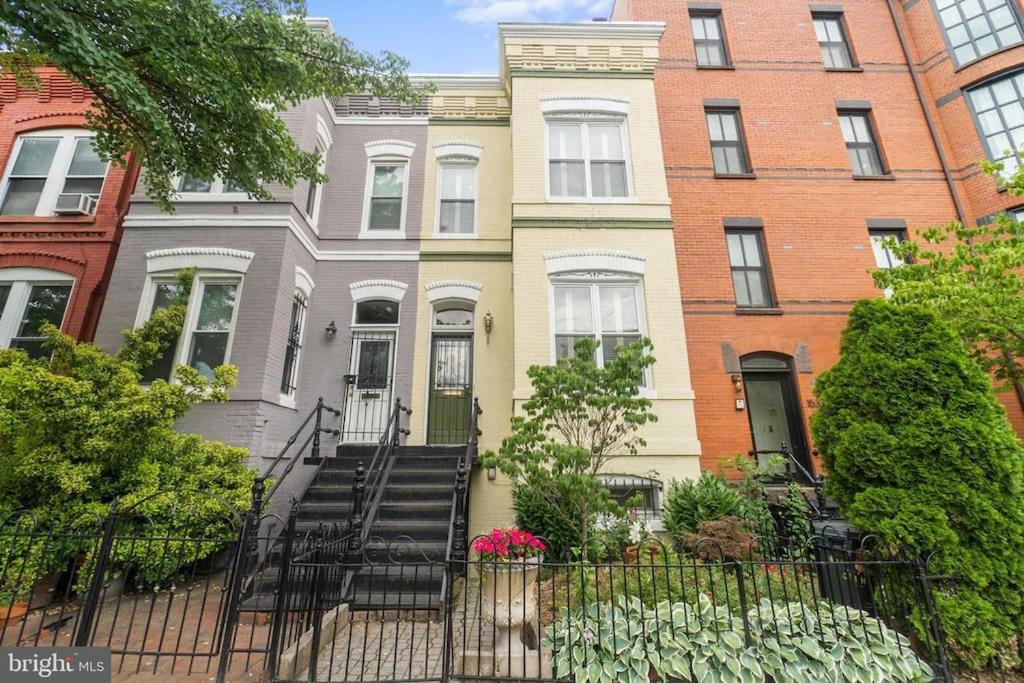 a row of houses with stairs in front of them at Stay in the heart of Logan Circle: Fully Walkable in Washington, D.C.