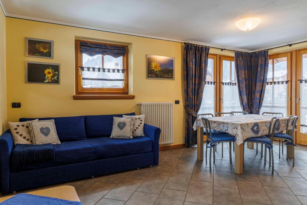 sala de estar con sofá azul y mesa en Chalets Molin en Livigno