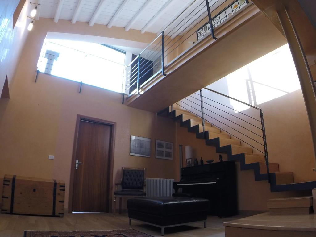 a living room with a staircase and a stair case at I Campanili in Agrigento