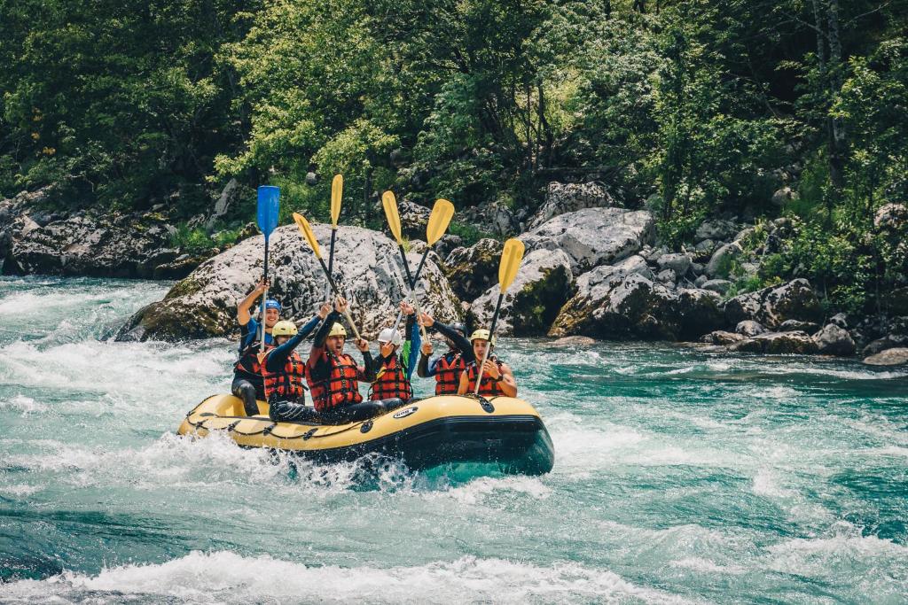 a group of people in a raft on a river at Camp Divlja Rijeka in Hum
