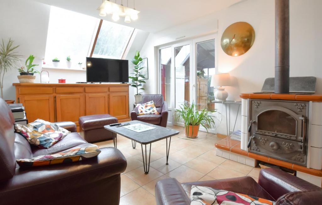a living room with a couch and a fireplace at Holiday Home Agon Coutainville in Agon Coutainville