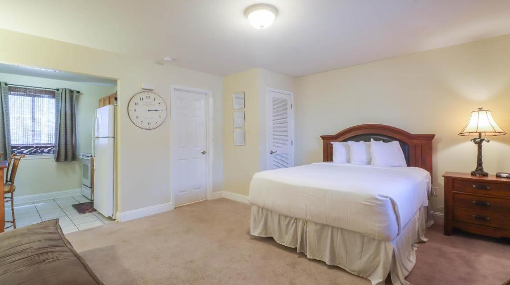 a bedroom with a bed and a clock on the wall at Oak Shores Studio 39 in Biloxi
