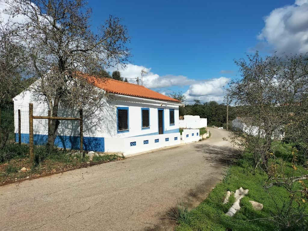 a white house with an orange roof on a road at Private Pool Fazenda Terrace Villa in Silves