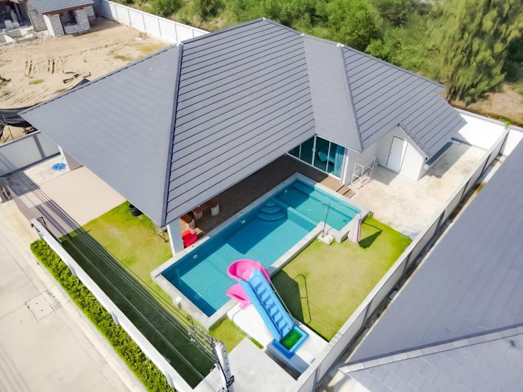 Cette chambre offre une vue sur une maison dotée d'une piscine. dans l'établissement Temmy Pool Villa, Chaam - Hua Hin, à Phetchaburi