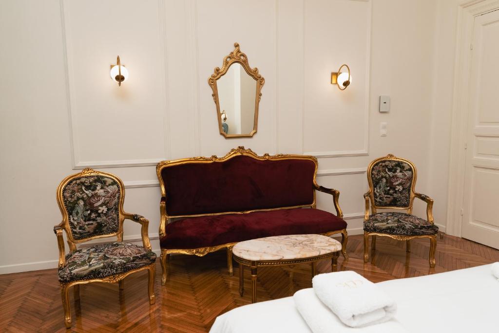 a room with two chairs and a couch and a mirror at Villa Clio, a Luxury Collection in Thessaloniki