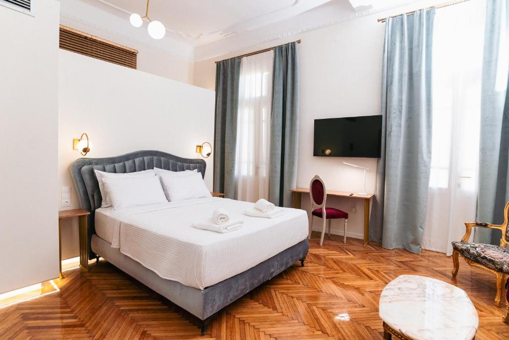 a hotel room with a bed and a tv at Villa Clio, a Luxury Collection in Thessaloniki