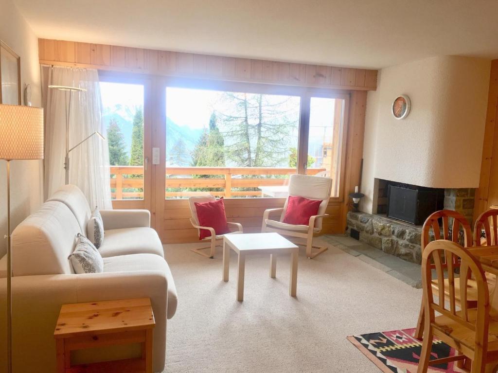 a living room with a couch and a fireplace at Amadeus 132 in Verbier