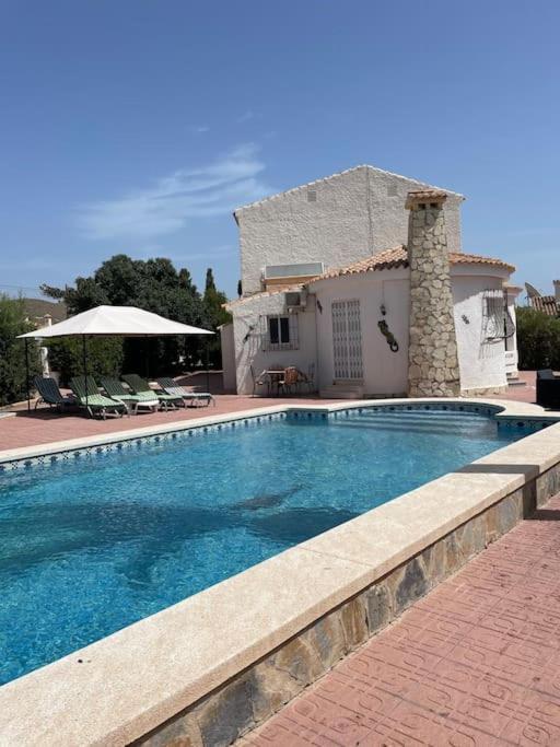 a swimming pool in front of a house at Casa Beavan in Alicante