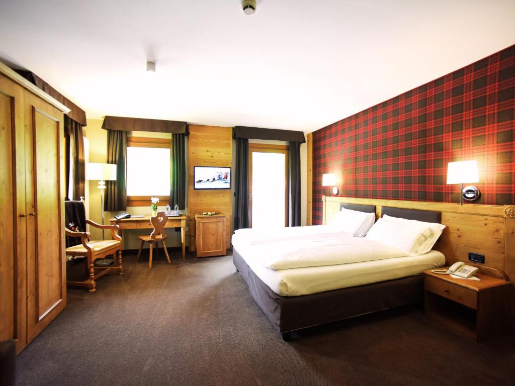 Posteľ alebo postele v izbe v ubytovaní Hotel Orso Grigio