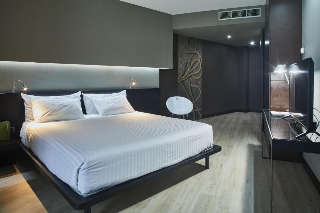 Cama o camas de una habitación en Silken Gran Teatro