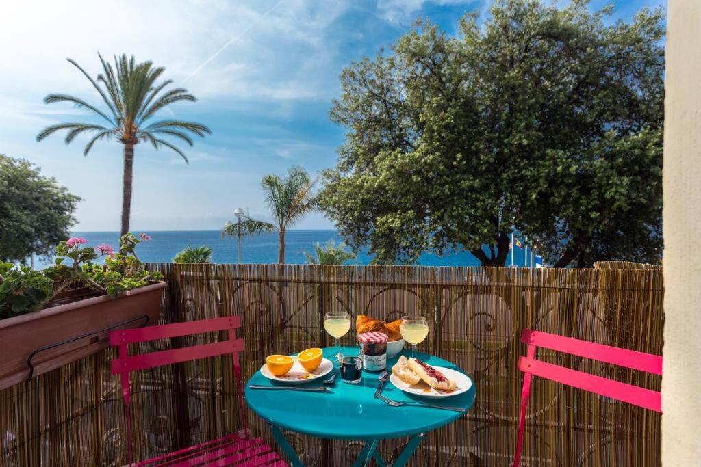 a blue table with food and wine glasses on a patio at ETATS UNIS 892 - Spacious flat on Sea front w/AC in Nice