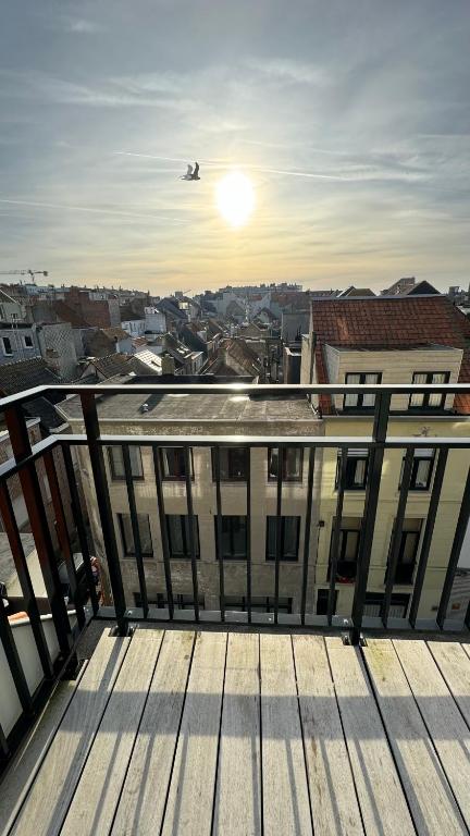 a view from the balcony of a building with an airplane at Viki's penthousje in Blankenberge