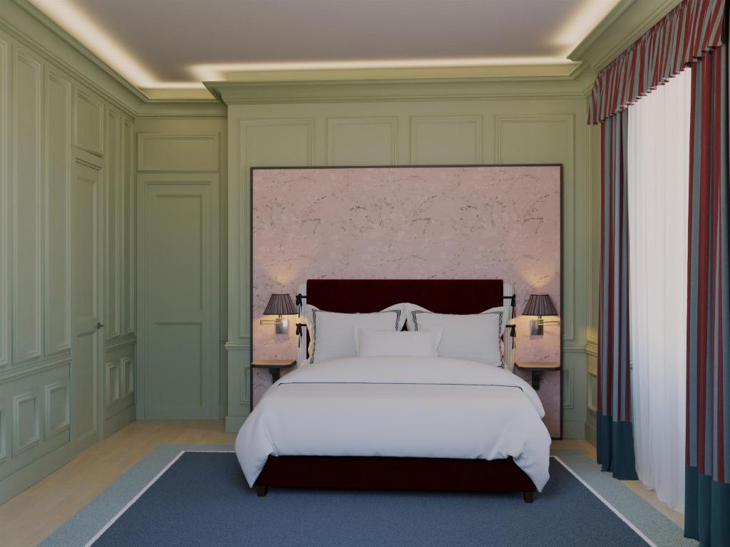 a bedroom with a large white bed and two lamps at Room Mate Isabella in Florence