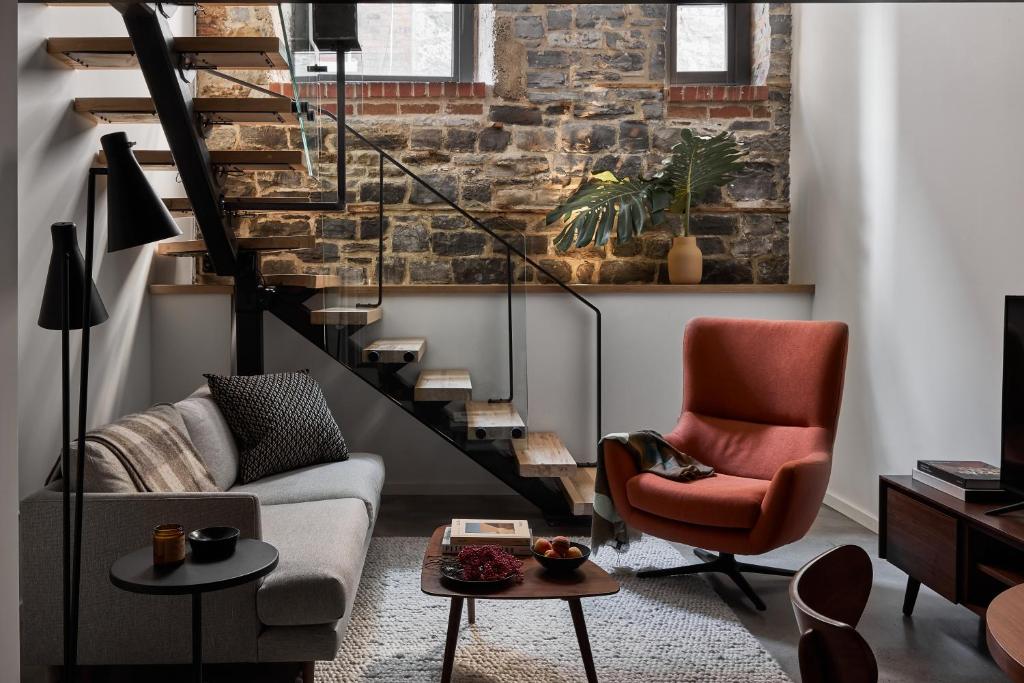 a living room with a couch and a chair at The Smith Hotel in Kingston