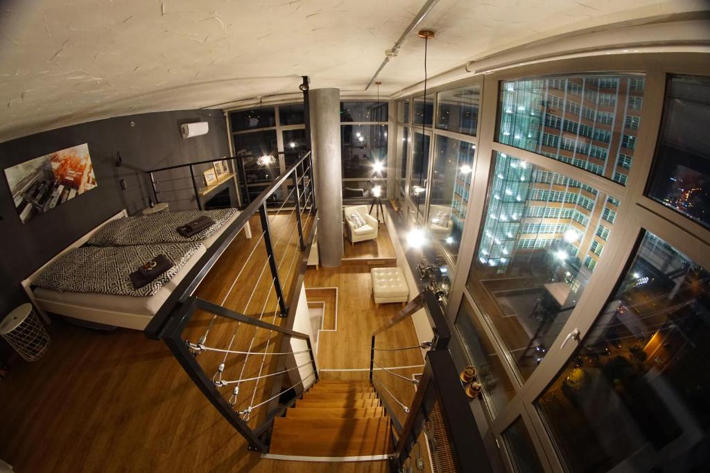 an overhead view of a room with a bed and a balcony at View Skyscraper Bata - loft XL in Zlín