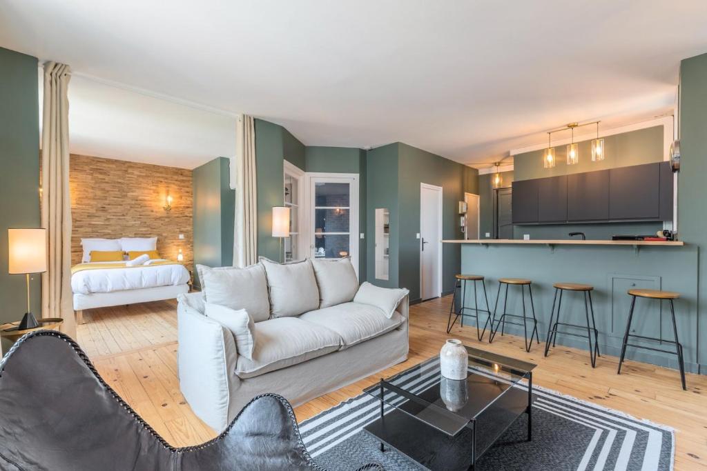 un salon avec un canapé et une cuisine dans l'établissement Charming 2 bedroom apartment - Old Lille, à Lille