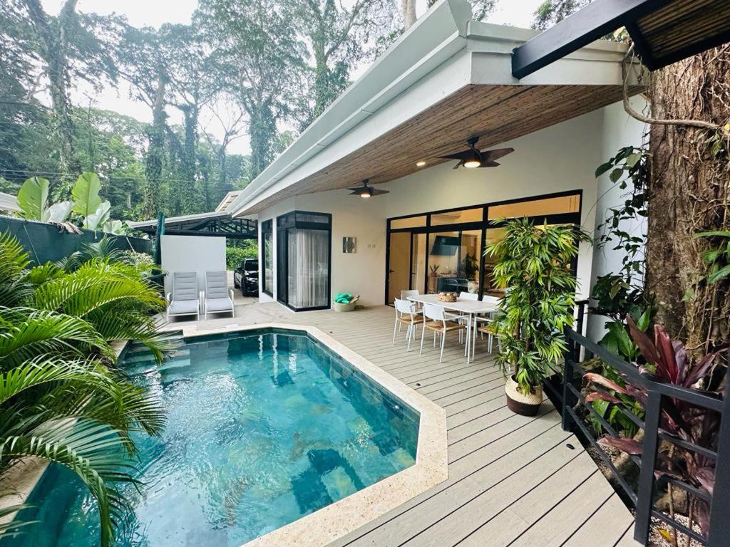 a house with a swimming pool on a wooden deck at Casa Coral Azul in Cahuita