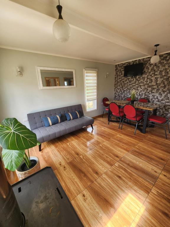 ein Wohnzimmer mit einem Sofa und einem Tisch in der Unterkunft Casa familiar in Cochrane