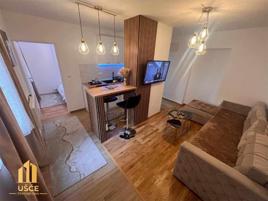 a living room with a desk and a couch at Apartman Ušće in Foča