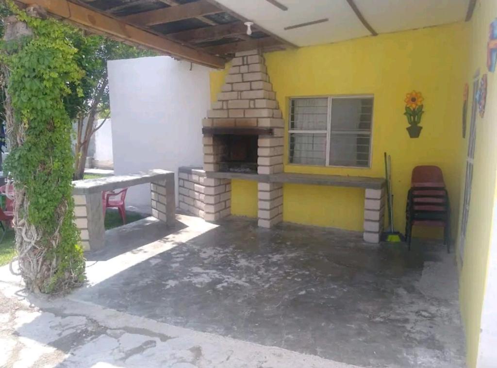 a patio with an outdoor fireplace in a house at Descanso los palmitos in Cuatrociénegas de Carranza