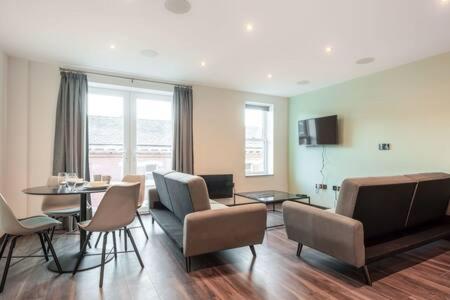 a living room with a table and chairs and a dining room at Smart 2 Bed Apartment with Parking in Central Hull in Hull