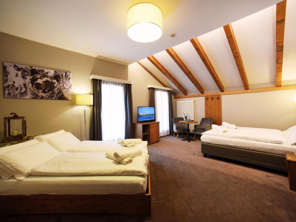 Posteľ alebo postele v izbe v ubytovaní Hotel Orso Grigio